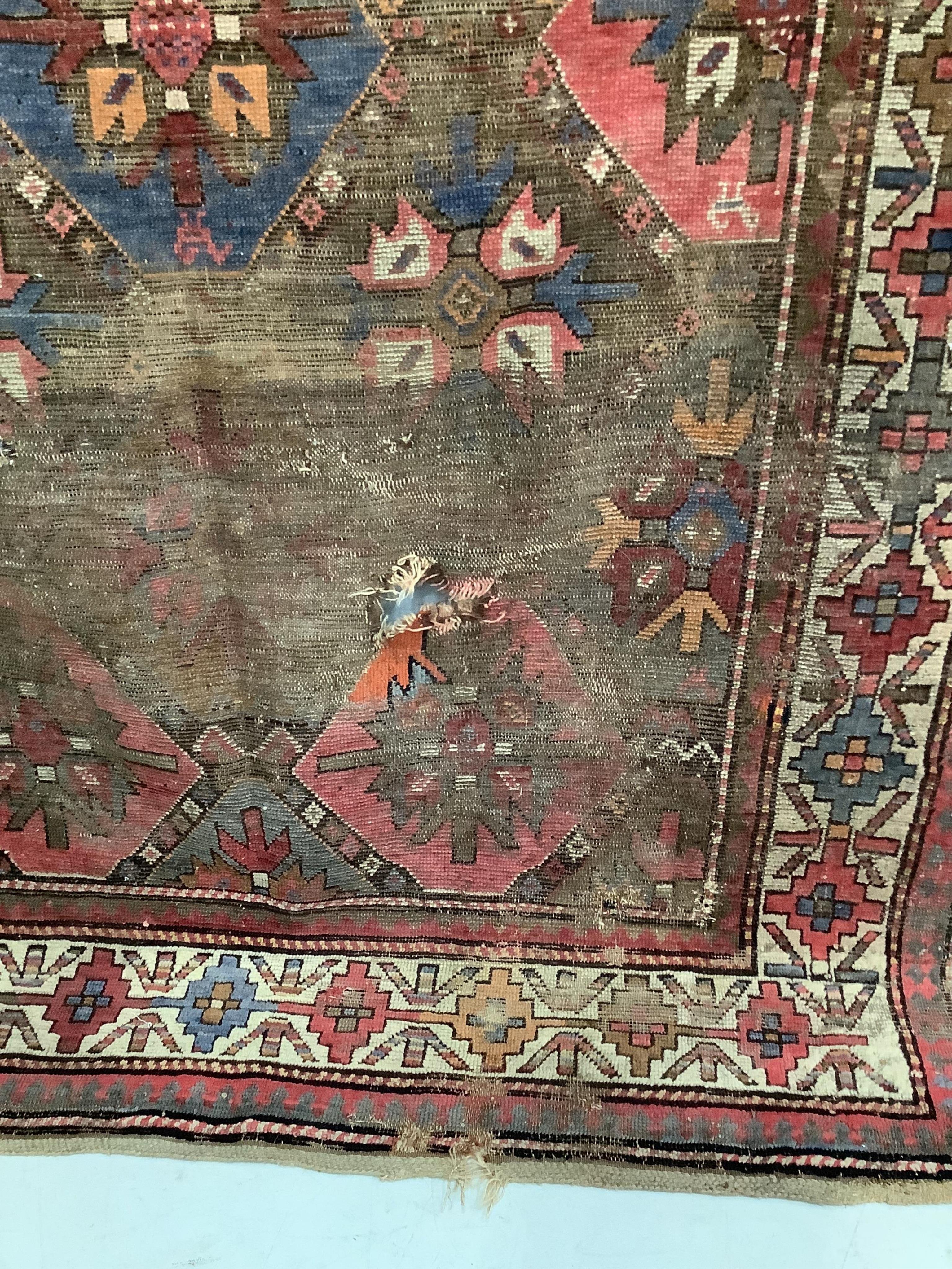 An antique Caucasian geometric rug, 250 x 140cm. Condition - poor